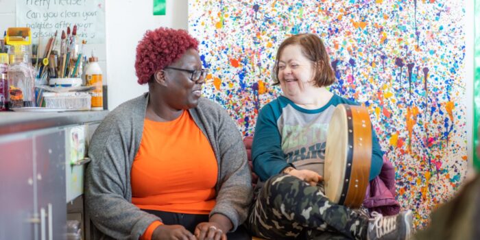 Two people in a room playing the drums