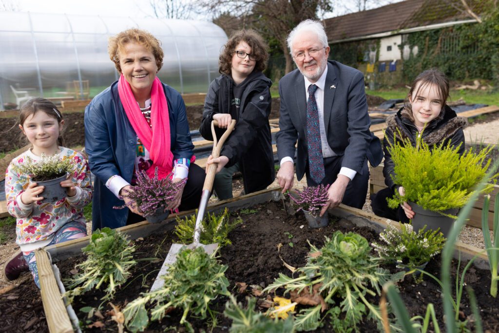 Young children at Crumlin biodiversity project planting with Minister of State Malcolm Noonan TD and Chief Executive Denise Charlton. 