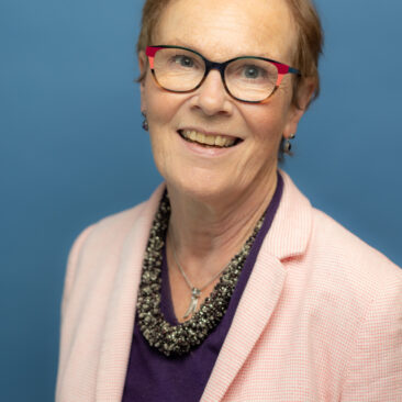 Noeline Blackwell Headshot on a blue background