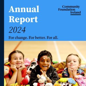 Cover of Annual Report 2024, with cover picture of three smiling children surrounded by toys from the local library, supported by Community Foundation Ireland. The Photo contains a link to the actual report.