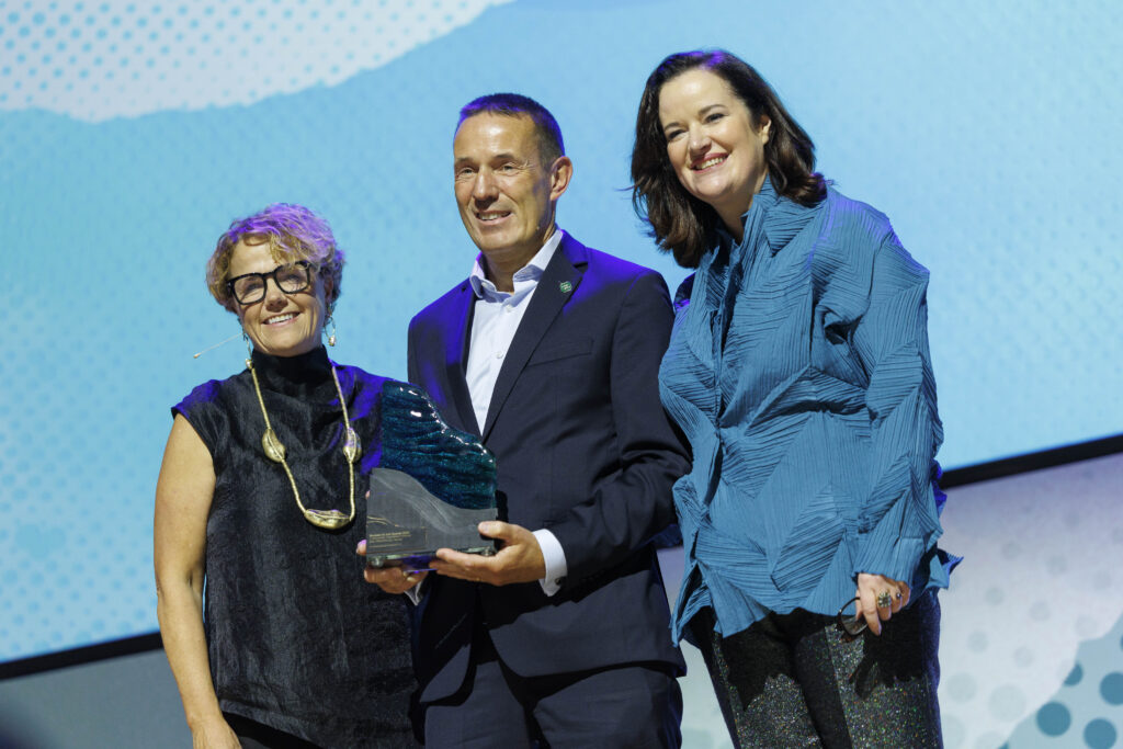 Three people at an award presentation. Denise of Community Foundation Ireland is on the left. Centre is David Lane from Ecclesiastical Insurance he is holding the 2026 Philanthropy Award, while on the left in blue is Louise of Business to Arts.