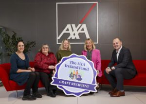 5 members of the AXA fund hold a cardboard cut-out Infront of AXA logo 