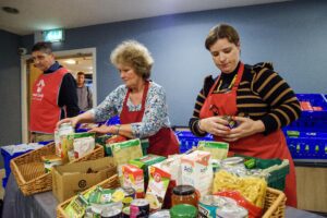 Two ladies packing food in Feed cork 