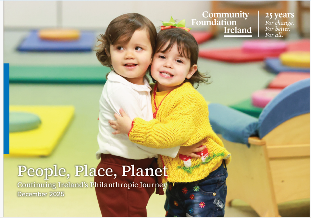 Two young children dressed brightly in a play environment. This is the cover of the 25-year Impact Report from Community Foundation Ireland. Click on Link to Access Report.